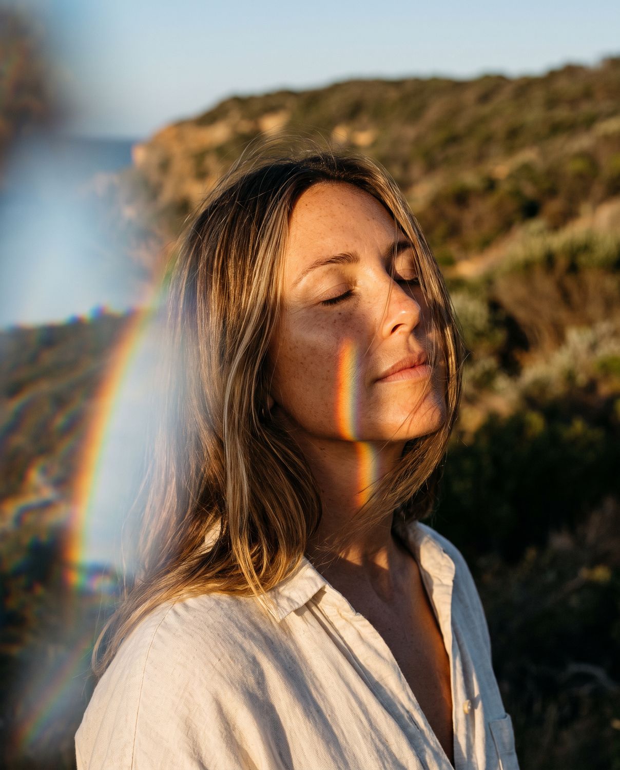 Prism light across a woman's face